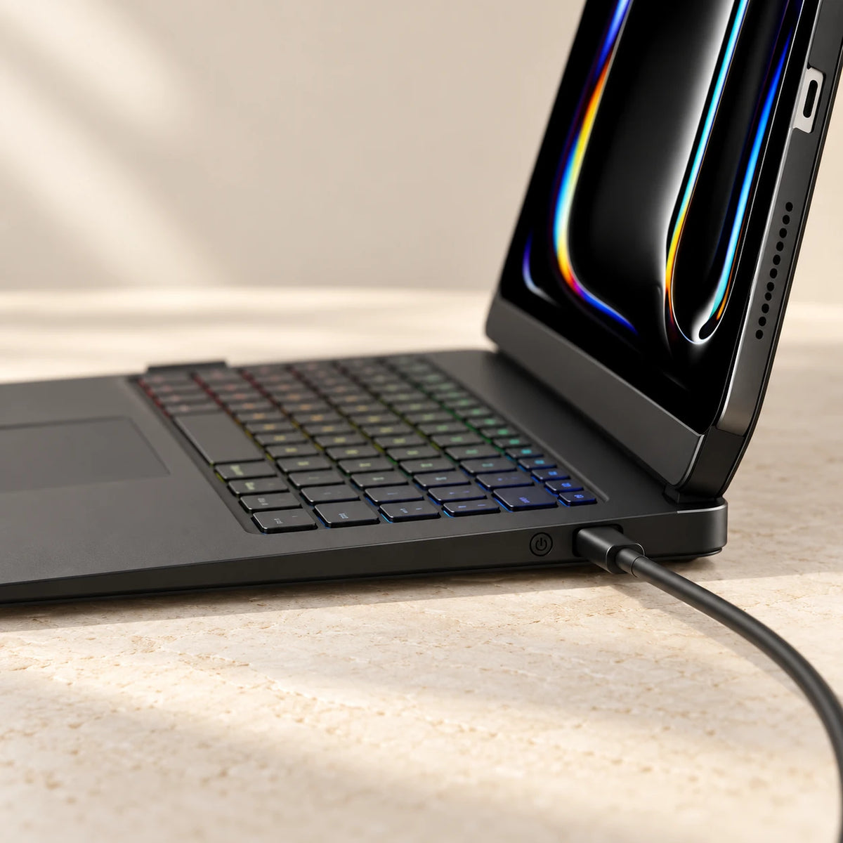 Charging cable connected to the side USB-C port of an open black tablet keyboard case.