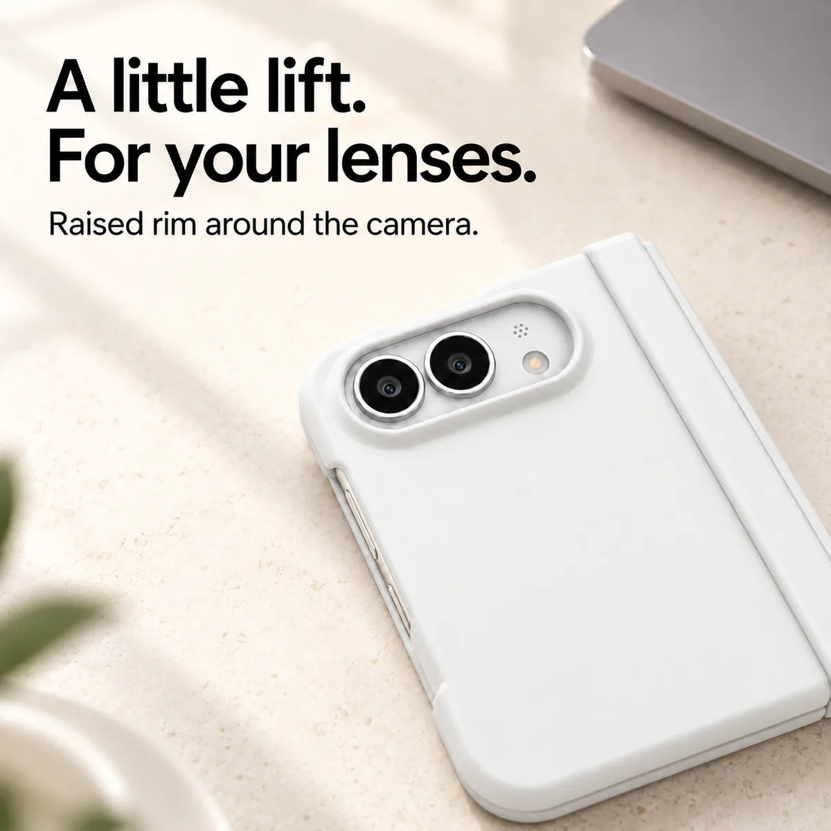 Close-up of the raised White camera rim on a matte iPhone Ultra case resting on a light desk. #color_Porcelain White